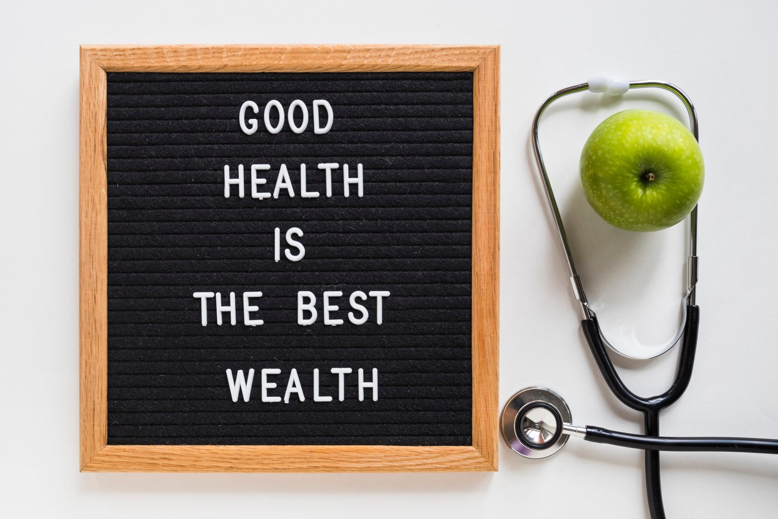 good-health-message-board-with-green-apple-stethoscope-white-background